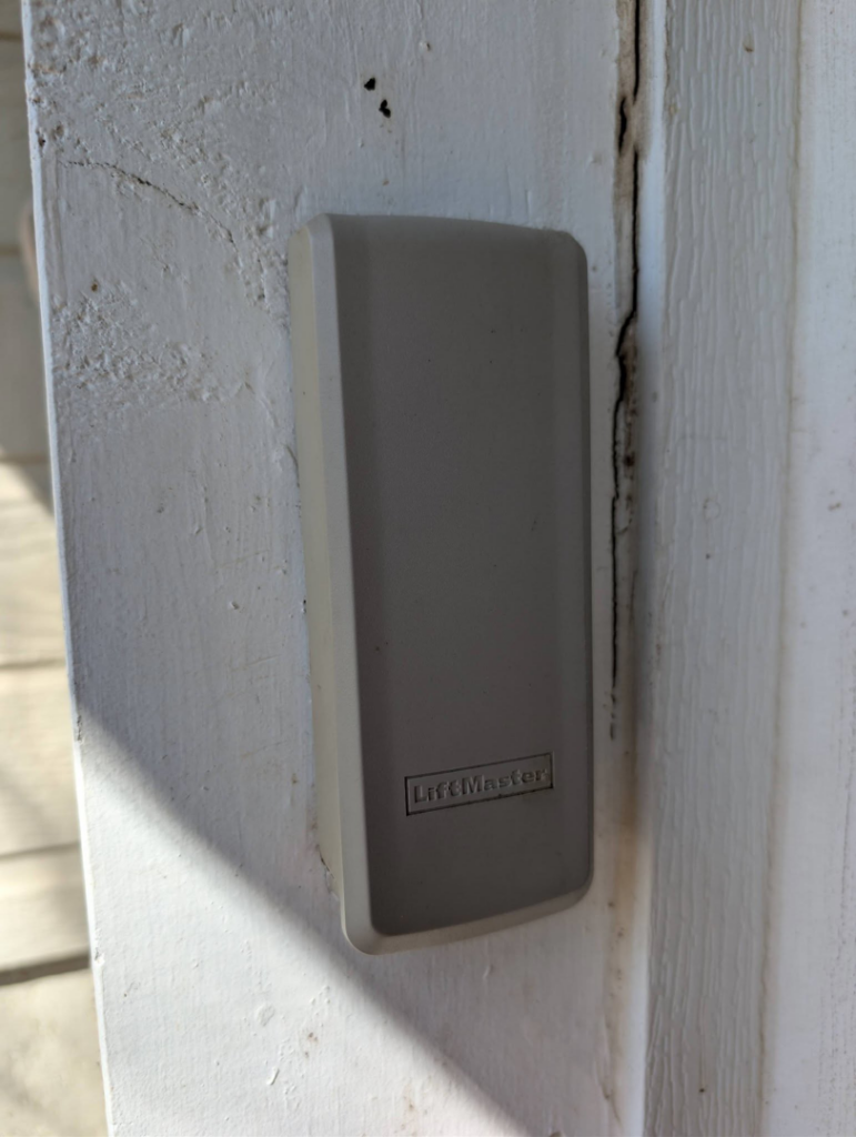 A close-up of a LiftMaster garage door keypad or sensor cover installed by Garage Doors & Remodeling LLC in Blue Springs, MO