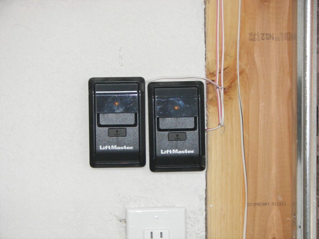 Two LiftMaster garage door opener wall controls installed by Sonoran Garage Doors in Mesa, AZ