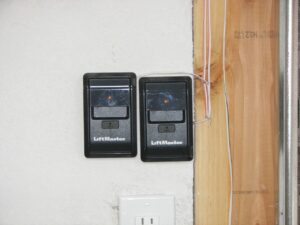Two LiftMaster garage door opener wall controls installed by Sonoran Garage Doors in Mesa, AZ