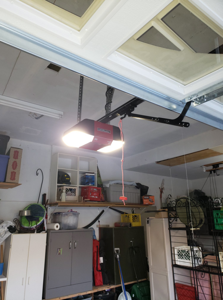 An interior view of a LiftMaster garage door opener and tracks installed by 170 Springs LLC Garage Doors in Aurora, CO