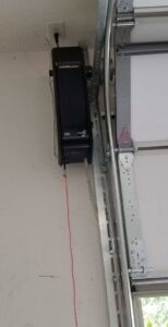 A LiftMaster garage door opener installed on the ceiling next to the door track by Affordable Overhead Garage Door in Modesto, CA