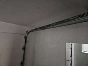A LiftMaster garage door opener motor installed on the ceiling, a service provided by Alliance Overhead Garage Doors Inc. in Portland, OR.