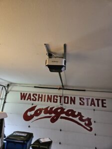 A LiftMaster garage door opener installed on the ceiling above a garage door by Babcock Garage Doors in Vancouver, WA
