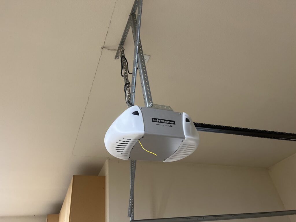A LiftMaster garage door opener installed on a ceiling, showcasing services by Mountain Fox Garage Doors in Colorado Springs, CO.