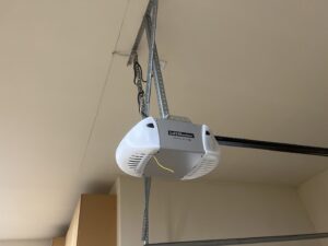 A LiftMaster garage door opener installed on a ceiling, showcasing services by Mountain Fox Garage Doors in Colorado Springs, CO.