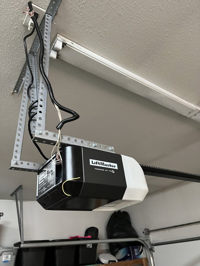 A close-up of a LiftMaster garage door opener motor and rail system installed by SCI Door in Yakima, WA