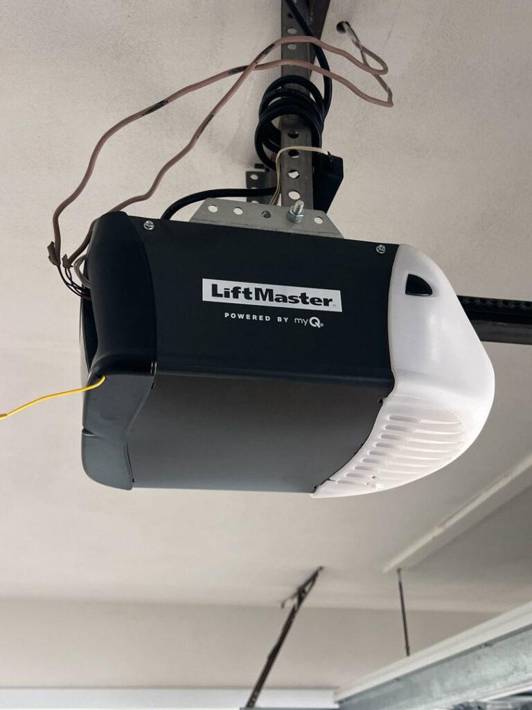 A LiftMaster garage door opener installed on the ceiling, demonstrating an installation by BSD Garage Door Service in Naperville, IL.