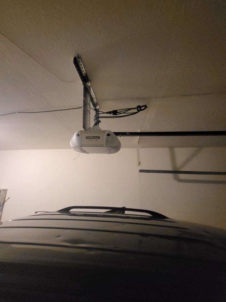 An installed LiftMaster garage door opener visible from inside a garage, serviced by Mountain Fox Garage Doors in Colorado Springs, CO.