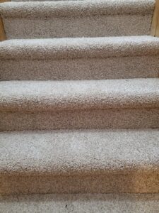 A beautifully installed light beige carpeted staircase by The Floor Store Inc. in Scranton, PA.