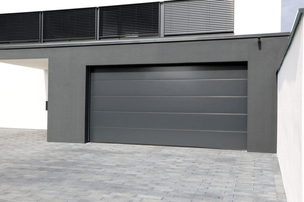A light beige garage door with windows on a modern home, installed by Your Other Front Door LLC in Lakewood, CO.