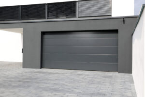 A light beige garage door with windows on a modern home, installed by Your Other Front Door LLC in Lakewood, CO.