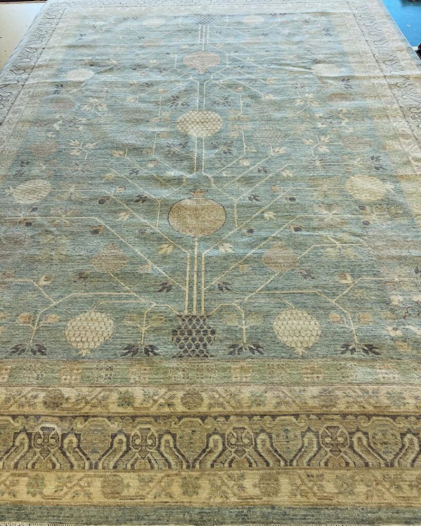 A beautiful light blue area rug featuring a tree-of-life pattern, offered by Yas Rugs in Lexington, KY.
