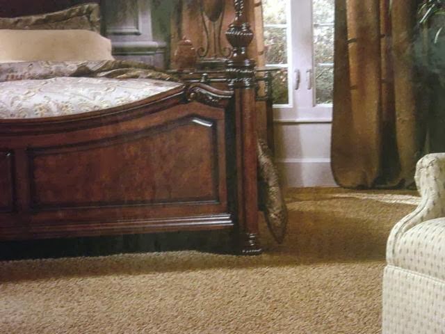 A bedroom with a warm light brown carpet installed by Floor Designs Unlimited, LLC in Pittsburgh, PA