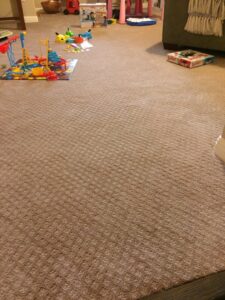 A room featuring a newly installed light brown patterned carpet by Carlson's Flooring in San Antonio, TX.
