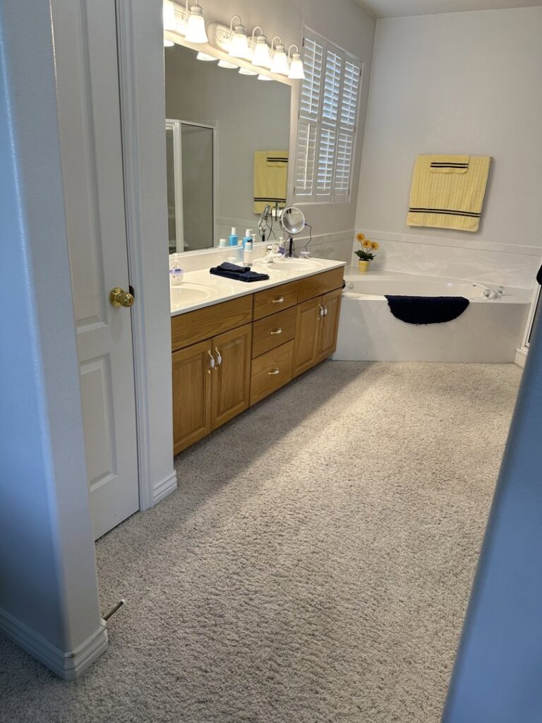 Light-colored carpet professionally installed in a bathroom by The Flooring Studio of St. George, UT.
