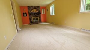 A spacious living room featuring a new light-colored carpet installation by National Carpet and Flooring in Tyngsboro, MA.