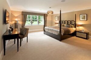 A spacious master bedroom featuring a new light-colored carpet installation by National Carpet and Flooring in Tyngsboro, MA.