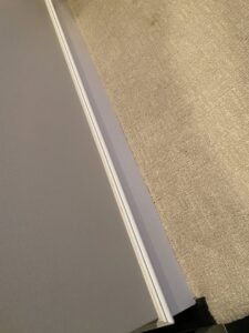 Newly installed light-colored carpet neatly fitted against a white wall by Floor Gallery in Pearland, TX