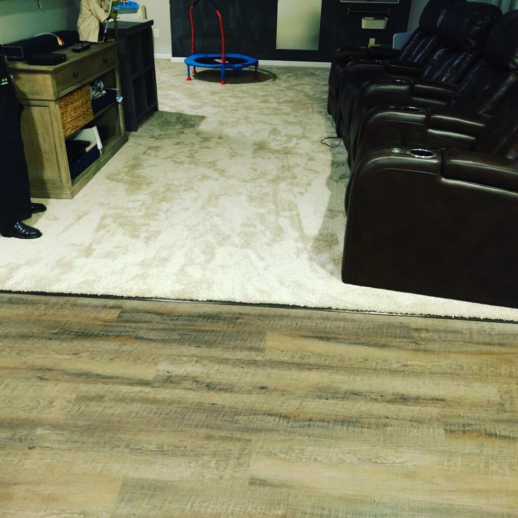 A room featuring a transition from light-colored carpet to wood-look vinyl flooring, installed by Home Based Carpet & Flooring in Cincinnati, OH.