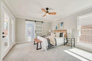 A light gray carpet installation in a bedroom by Texas Tuff Floors in Dallas, TX