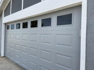 A stylish light gray panel garage door with rectangular windows installed by Calavera Garage Doors in Mesa, AZ