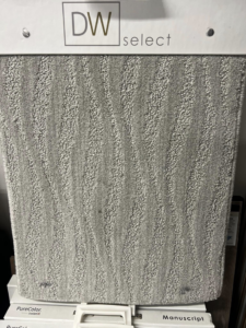 A close-up of a light gray wavy pattern carpet sample at West Michigan Flooring & Interiors in Byron Center, MI.
