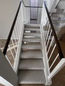 A residential staircase with new light grey carpet, installed by Canyon State Flooring in Queen Creek, AZ.