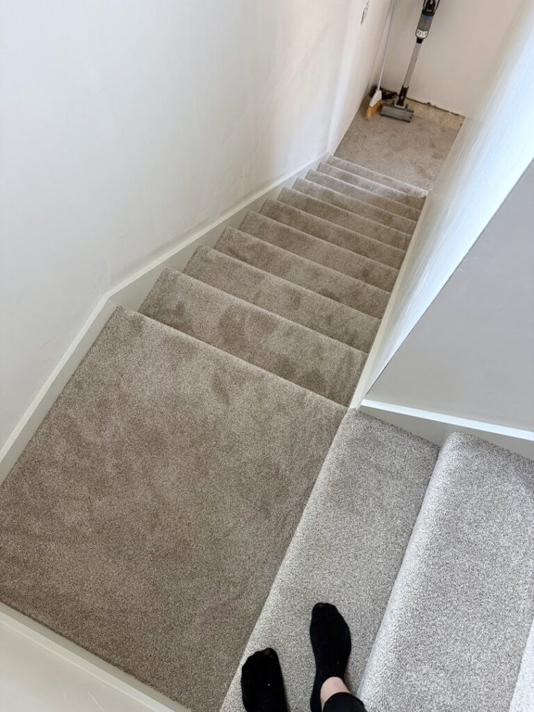 A light grey carpeted staircase installed by Concord Carpet Center LLC in Concord, NH