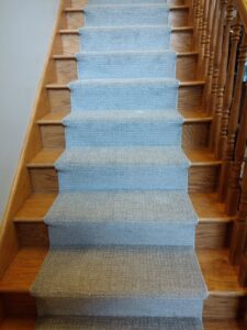 Newly installed light grey carpet on stairs by New City Carpet And Flooring, a professional carpet contractor in Chicago, IL