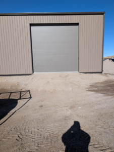 A light grey commercial garage door installed by Usa Garage Door Services and Construction, LLC at 1206 E 6th St, USA.