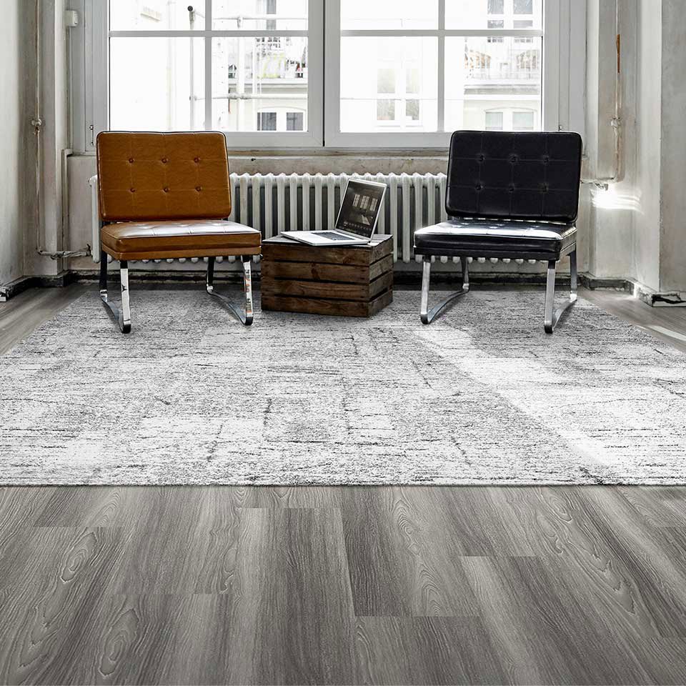 A light grey patterned area rug or carpet enhancing a room's decor, provided by Eastpointe Interiors in Caledonia, MI.