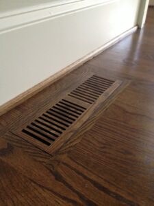 Light hardwood flooring installed in an entryway, showcasing quality work by Peach Design Inc. in Atlanta, GA.
