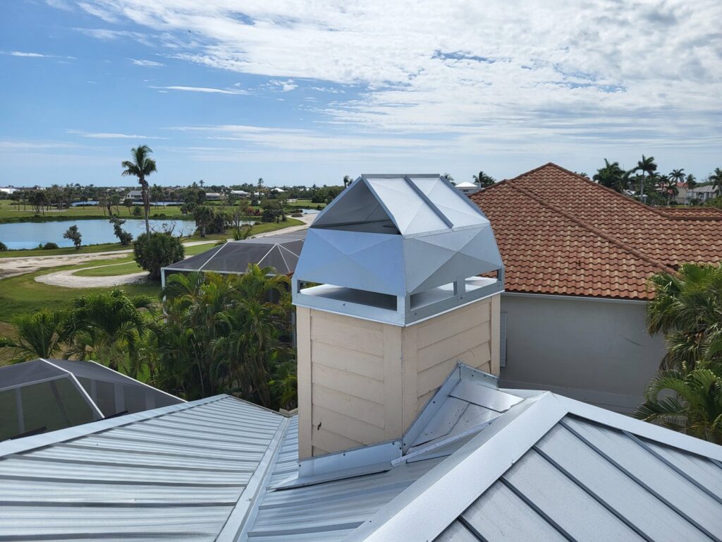 A light-colored modern chimney cap installed on a metal roof by SWFL Chimney Caps Inc. in Fort Myers, FL.