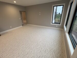 A room with newly installed light patterned carpet by Flooring World Wide LLC in Plainwell, MI.