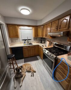 Durable light wood-look flooring installed in a cozy kitchen by Nations Best Flooring & Carpet Co. in Livonia, MI.