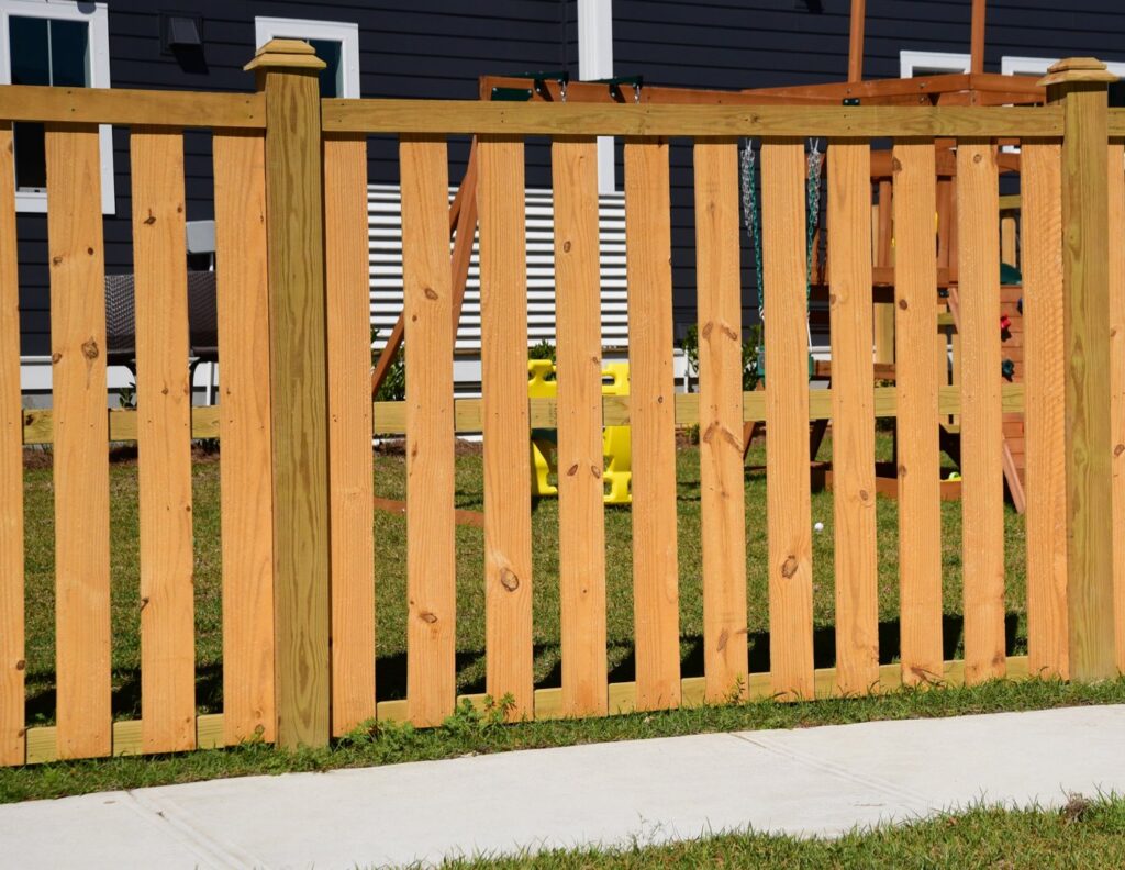 A light-colored wooden privacy fence installed in a residential area, providing backyard seclusion by Five Star Fence in Charleston, SC.