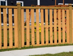 A light-colored wooden privacy fence installed in a residential area, providing backyard seclusion by Five Star Fence in Charleston, SC.
