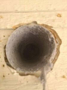 The interior of a lint-filled HVAC duct, highlighting the importance of professional cleaning by Aero Brush Duct Cleaning in Billings, MT.