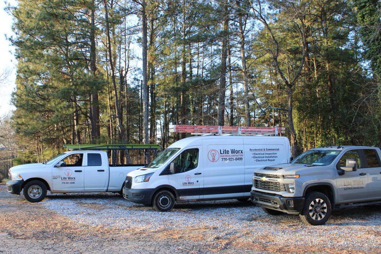 LiteWorx Electrical service vehicles, including a van and two trucks, ready for electrical jobs in Lilburn, GA.