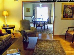 Oriental rugs placed in both a living room and an adjacent dining room, showcasing work by Brandon Oriental Rugs in Furlong, PA.