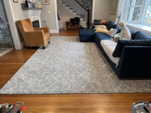 A beautifully installed area rug in a living room by Harry's Carpet One in Quincy, MA.