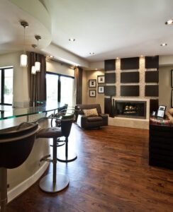 A living room and bar area illuminated by stylish recessed and pendant lighting installed by Castle Electrical & Lighting in Scottsdale, AZ.