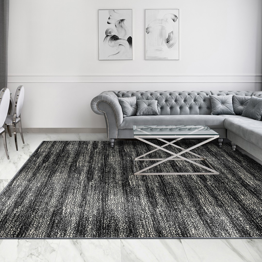 A modern living room featuring a large black and white patterned area rug from Artifacts Fine Rugs and Flooring in South Salt Lake, UT.