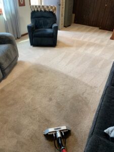 A living room carpet being cleaned, showing clean and uncleaned areas, by Carpet Cleaning Pros LLC in Eau Claire, WI.