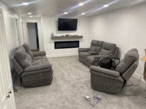 A modern living room with newly installed light grey carpet by All about flooring utah in Salt Lake City, UT.