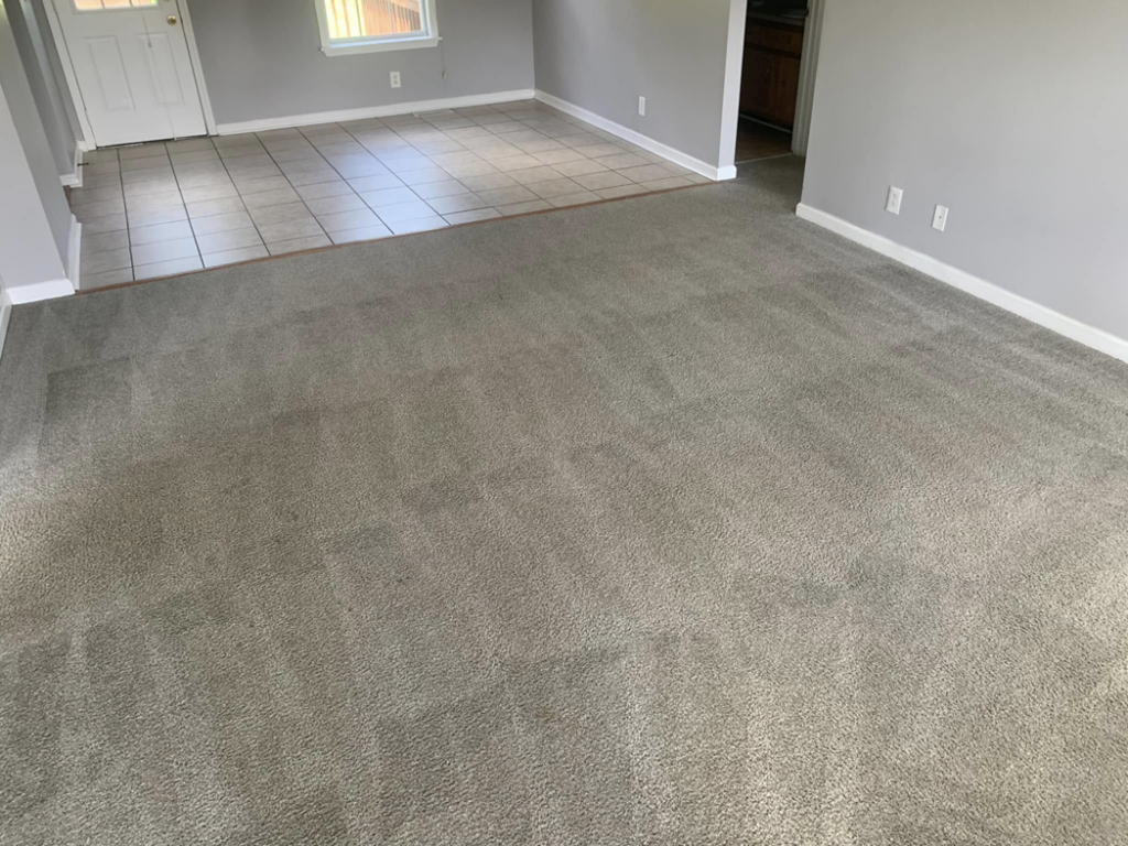 A spacious living room with new grey carpet installed by Briggs Cleaning in Clarksville, TN.