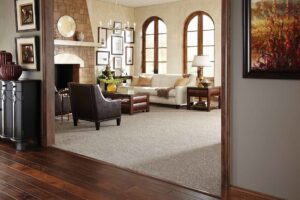 A spacious living room featuring new light brown wall-to-wall carpet installed by Elite Flooring America in Decatur, AL.