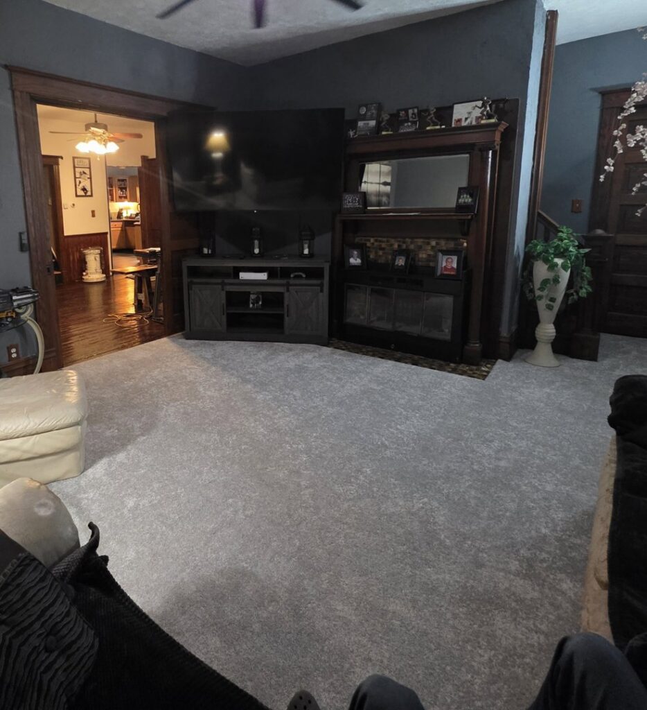 A living room with new light gray carpet installed by Flooring World Wide LLC in Plainwell, MI.