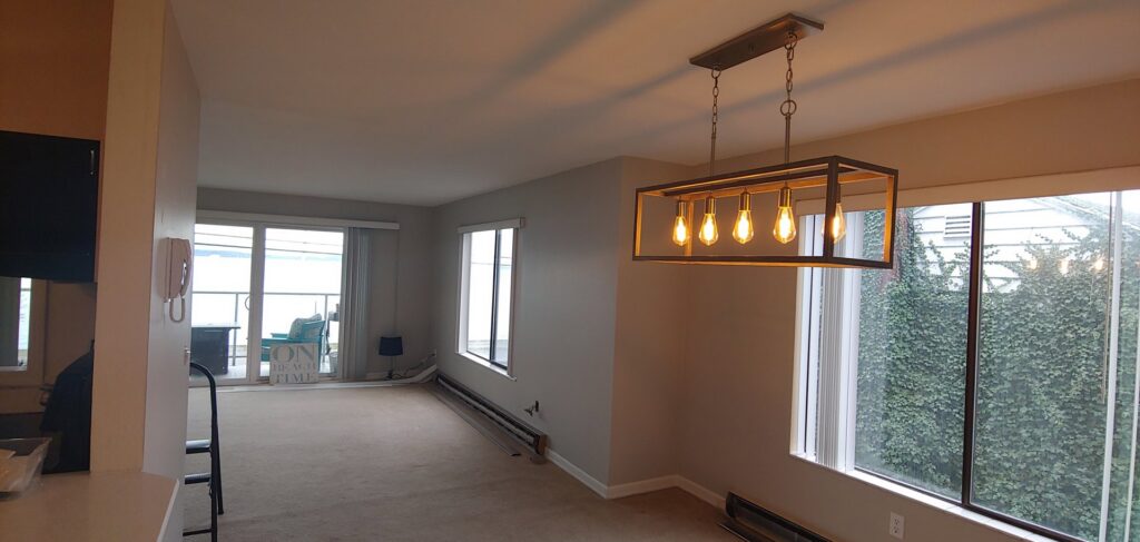 A spacious living room featuring new light-colored carpet installed by H&G Remodel in Burien, WA.