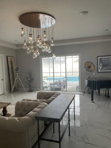 Elegant living room featuring a large, multi-bulb chandelier installed by Heck Electric, LLC in Everett, WA